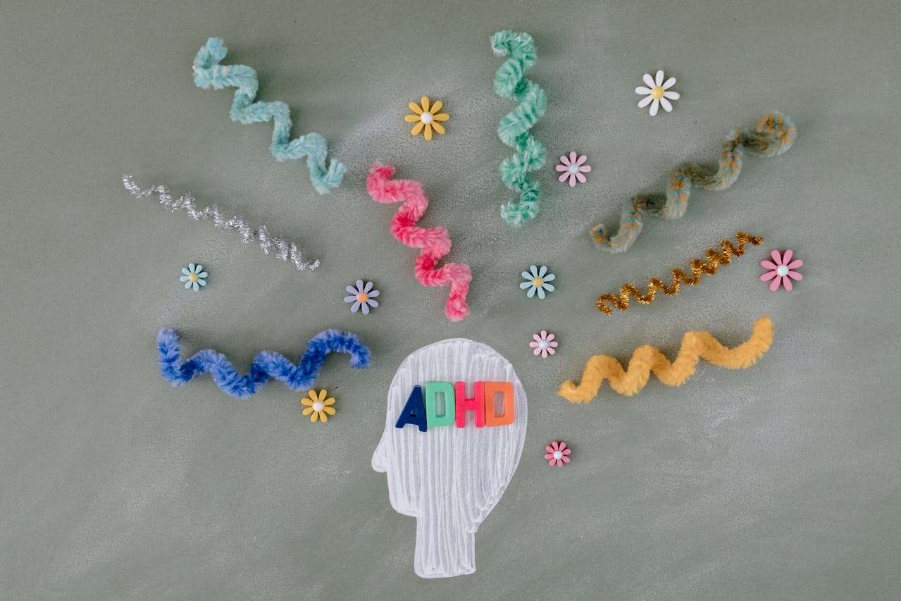 An illustration showing the ADHD mind of a person in colourful spiral materials and flowers.