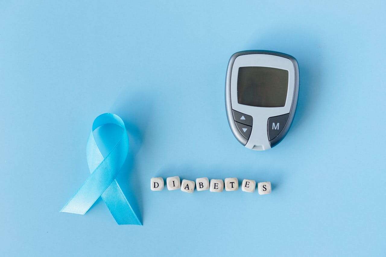 The image shows a blood glucose meter and blocks of letter arranged to read Diabetes.